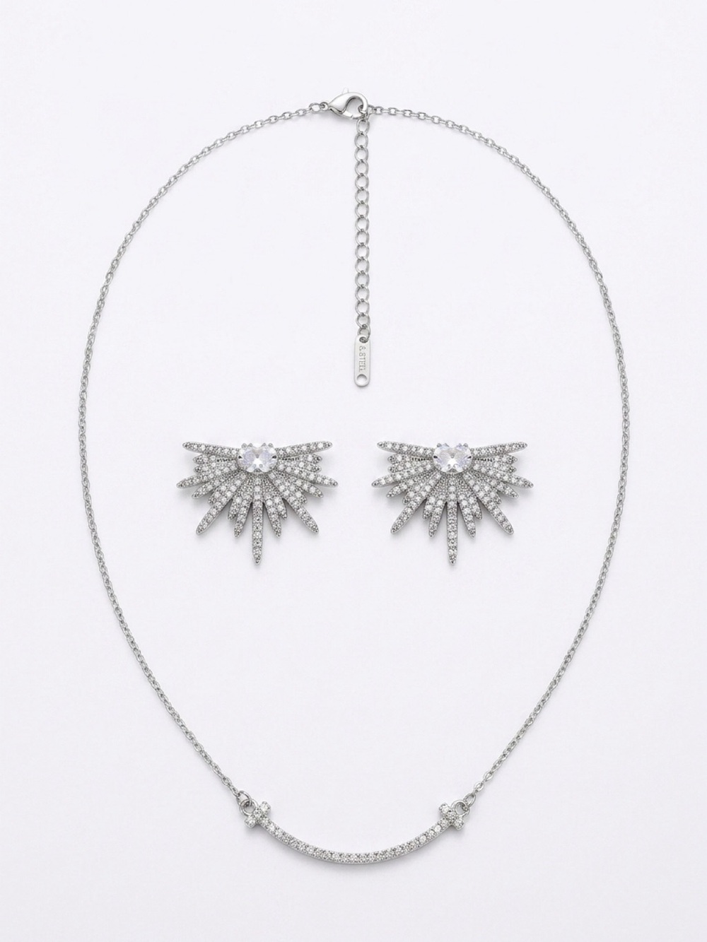 Silver Tone Faux Crystal Starburst Earrings with matching necklace.